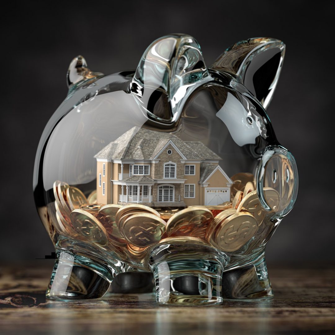 Glass piggy bank with coins and house. Mortgage, savings for real estate or to buy a house concept.